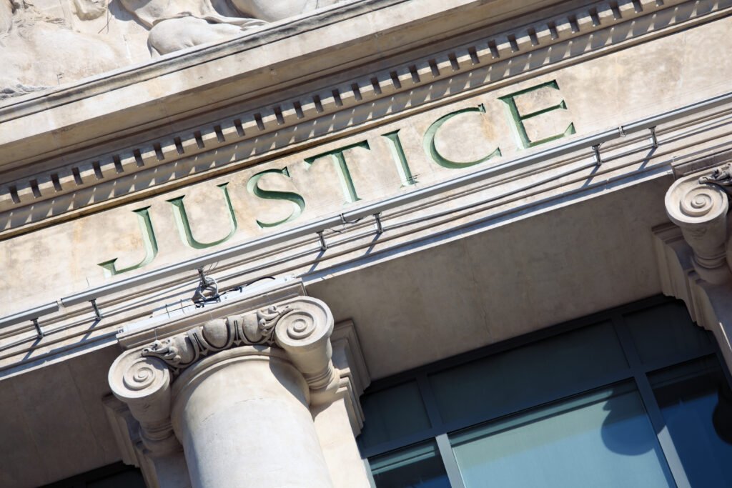 The word Justice on a Courtroom Building. One of the places where law is exercised. 